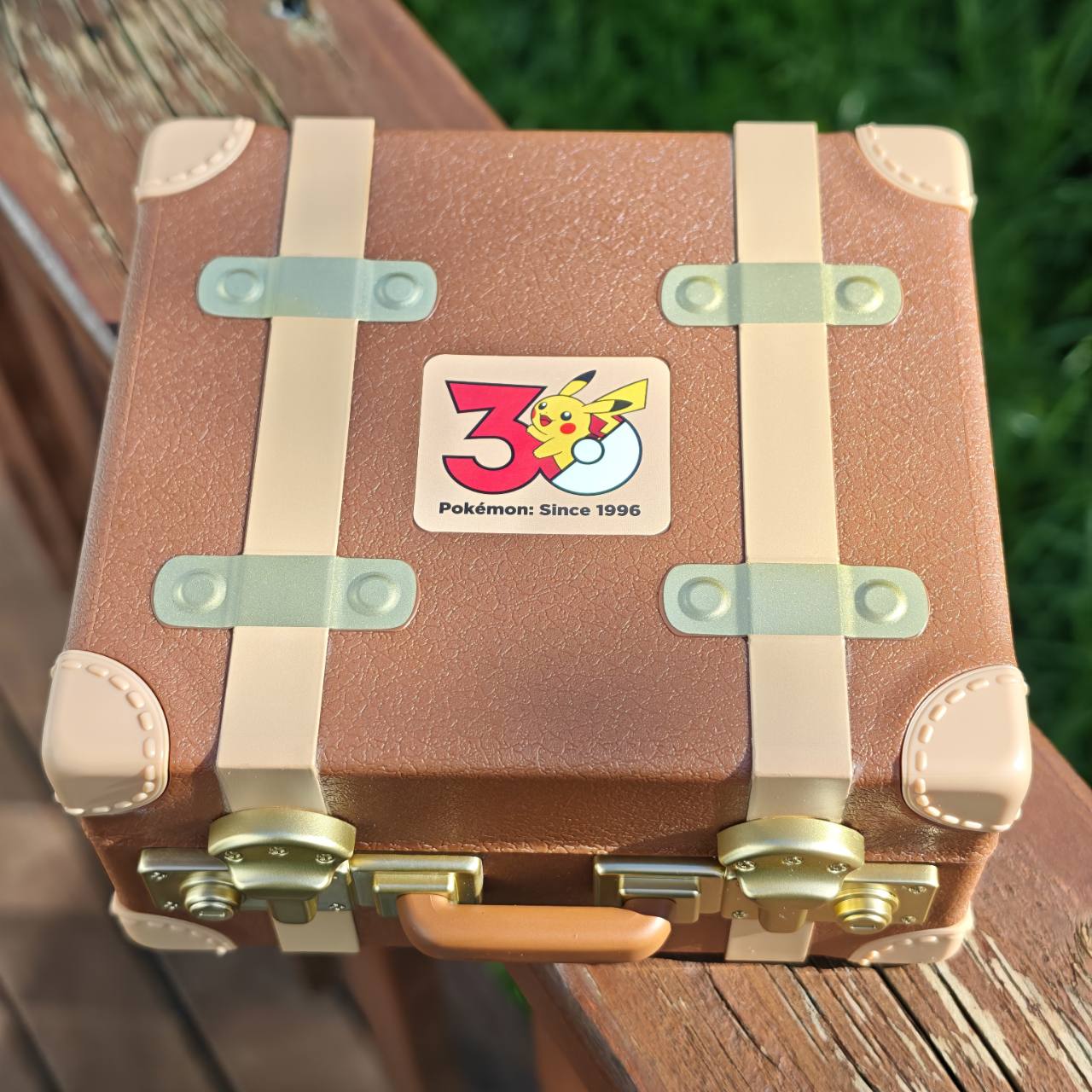 
Closed Pokémon First Partner miniature suitcase with the 30th-anniversary emblem