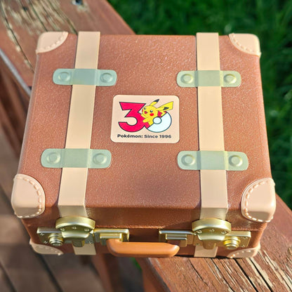 
Closed Pokémon First Partner miniature suitcase with the 30th-anniversary emblem